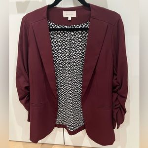 Skies Are Blue maroon blazer with black and white patterned lining.